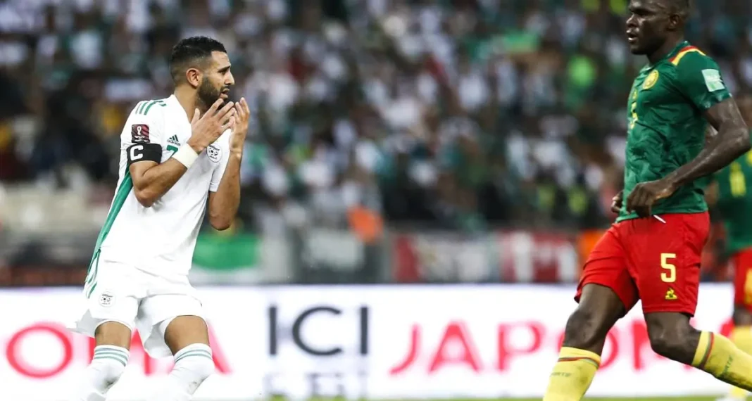 Joueur algérien en célébration face au joueur camerounais lors du match.