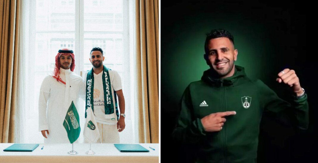 Riyad Mahrez en tenue de sport, souriant et montrant un signe de victoire.