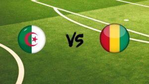 Drapeaux de l'Algérie et de la Guinée sur un terrain de football.