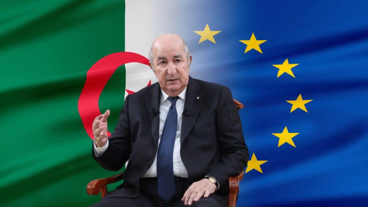 Homme en costume devant les drapeaux d'Algérie et de l'Union européenne.