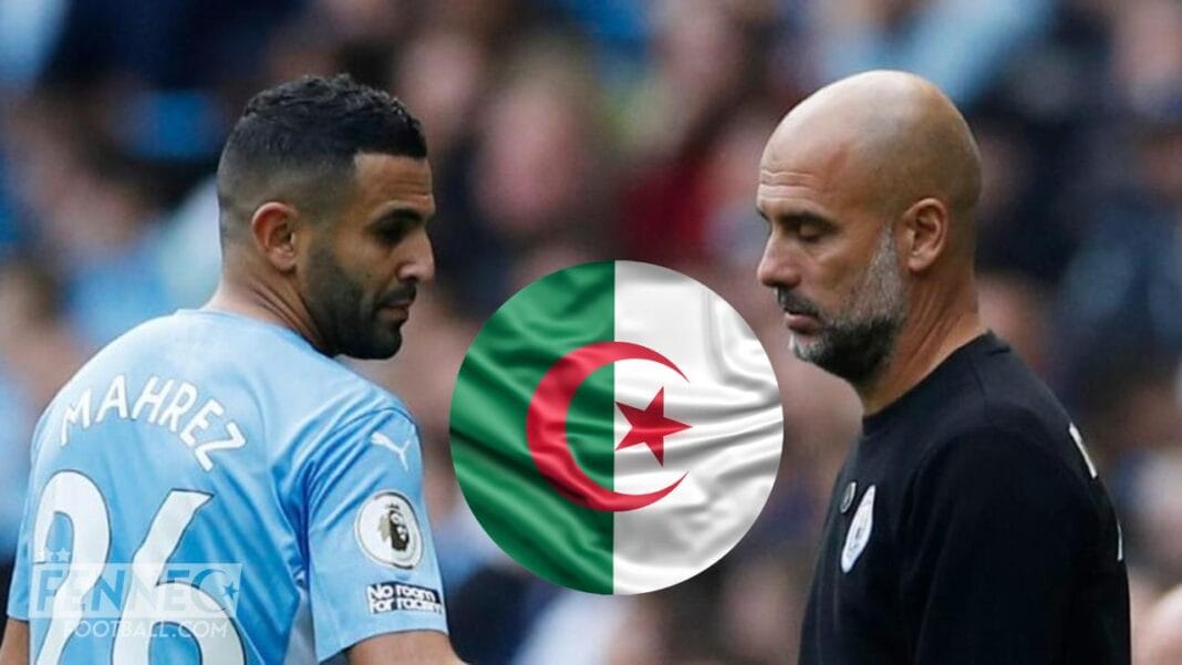 Mahrez et Guardiola en discussion sur le terrain de football.