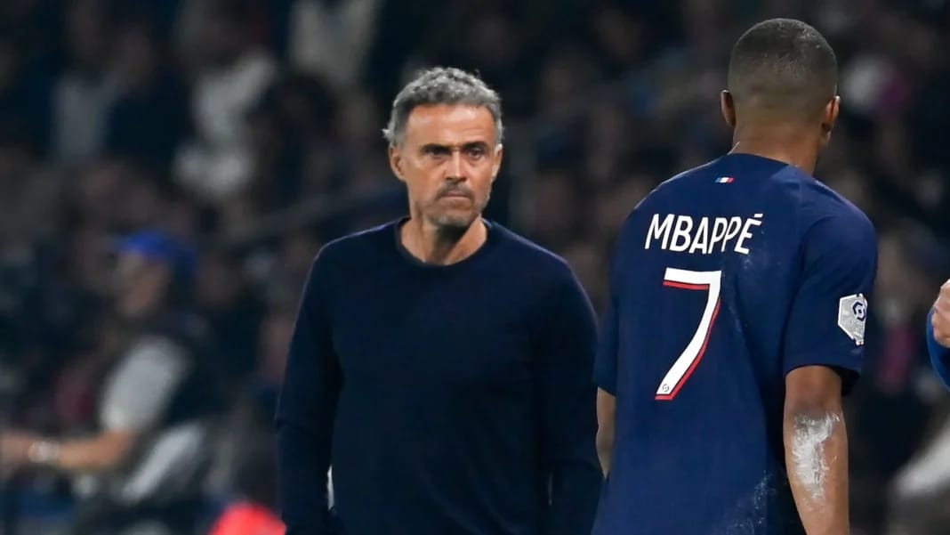 Kylian Mbappé et l'entraîneur Luis Enrique lors d'un match de football.