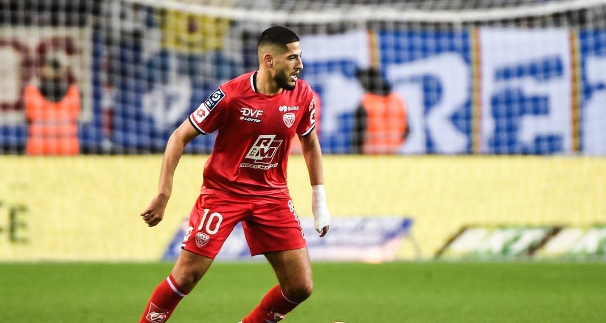 Yassine Benzia portant le maillot rouge en pleine action sur le terrain.