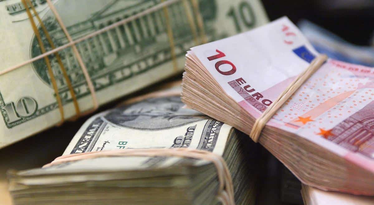 Foule de billets de banque en euros et dollars en gros plan.