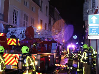 Pompiers en action lors d'un incendie dans une rue d'Ayad la nuit.