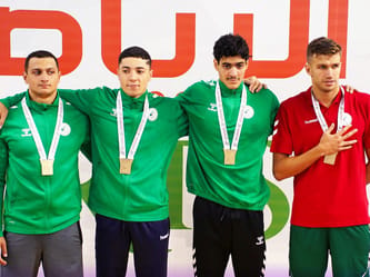 Groupe de gymnastes masculins algériens avec médailles d'or.