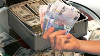 Main tenant des billets de banque en euros dans une mallette en métal.