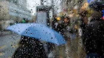Parapluie bleu sous la pluie à Alger, vue floue.