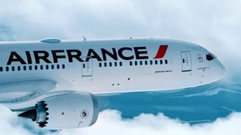 Avion Air France survolant les nuages, prêt à atterrir en Algérie.