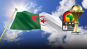 Drapeau algérien flottant avec trophée de la CAF dans le ciel.