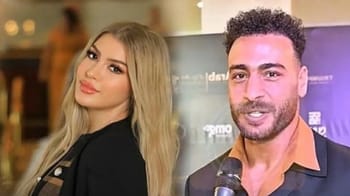 Homme et femme lors d'une interview, ambiance professionnelle et chaleureuse.