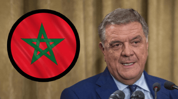 Député italien parlant avec drapeau du Maroc en arrière-plan.