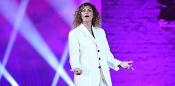Nawell Madani lors d'une performance sur scène avec éclairages violets.