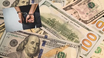 Main enchaînée tenant de fausses coupures de dollars et d'euros.