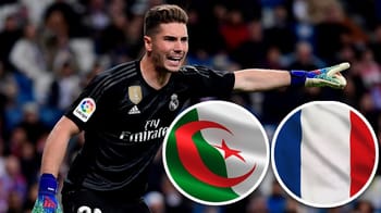 Luca Zidane, gardien de but, en pleine action avec drapeaux d'Algérie et de France.