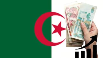 Main tenant des billets de banque algériens devant le drapeau national.