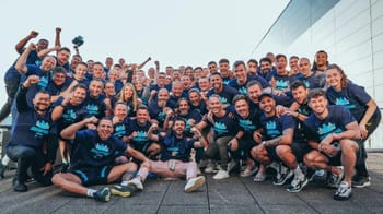 Groupe de sportifs souriants et célébrant leur victoire.