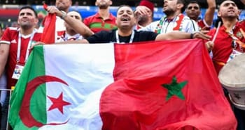 Supporters algériens avec drapeau national lors d'un match de football.