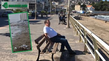 Touriste assis sur un banc près de la mer en Algérie.