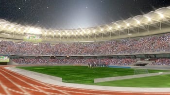 Stade d'athlétisme moderne en Algérie avec foule et éclairage nocturne.