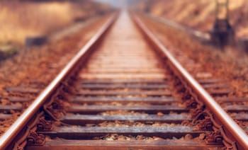Rails de chemin de fer abandonnées dans un paysage automnal.