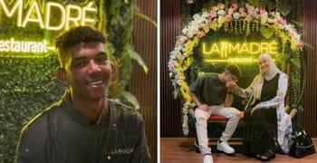 Deux personnes souriantes devant le restaurant La Madre avec décoration florale.
