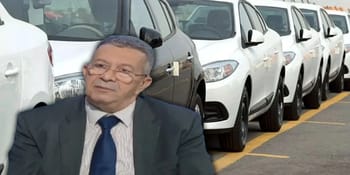 Homme d'affaires devant une rangée de voitures neuves en Algérie.