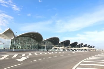 Aéroport d’Alger avec architecture innovante et large façade en verre.