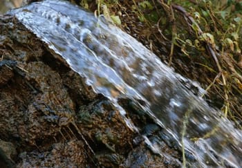 Source d’eau claire jaillissant sur roche à Ighil.