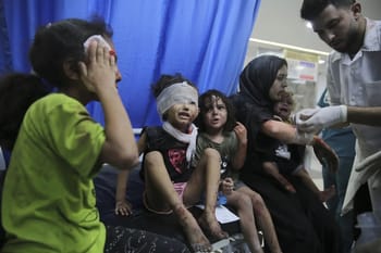 Enfants blessés recevant des soins médicaux en zone de conflit.