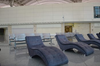 Espace détente avec sièges transat modernes à l'aéroport d'Alger.