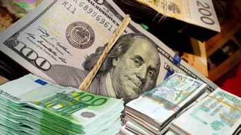 Billets de dollar et euro empilés, vue rapprochée.