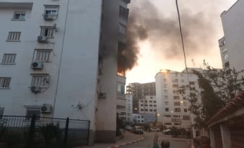 Feu dans un immeuble en Kabylie avec fumée noire.