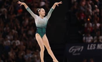 Gymnaste effectuant une figure lors d'une compétition de gymnastique.