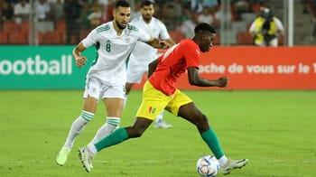 Joueur algérien en action contre un joueur marocain lors d'un match de football.