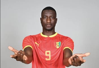 Footballeur en maillot rouge, prêt à jouer pour l'équipe nationale.