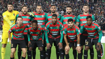 Groupe de joueurs du MC Alger lors d'un match de football.