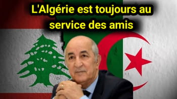 Homme en costume devant drapeaux de l'Algérie et du Liban.