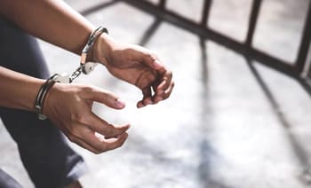 Main menottée en détention, symbole de justice et d'arrestation.