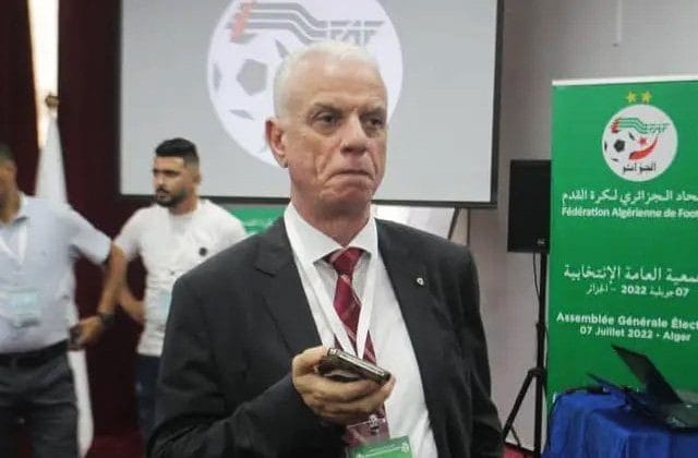 Homme sérieux en costume lors d'une réunion FIFA en Algérie.