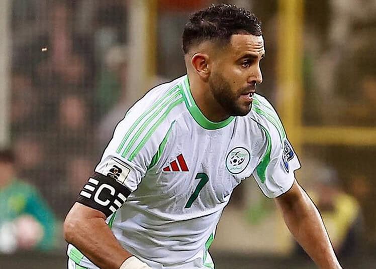 Riyad Mahrez en action lors d'un match de football avec l'équipe nationale algérienne.