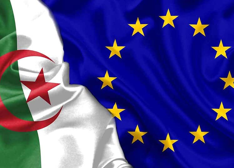 Pourquoi réviser l'accord Algérie-UE ? Découvrez ! Drapeau algérien et drapeau de l'Union Européenne côte à côte.