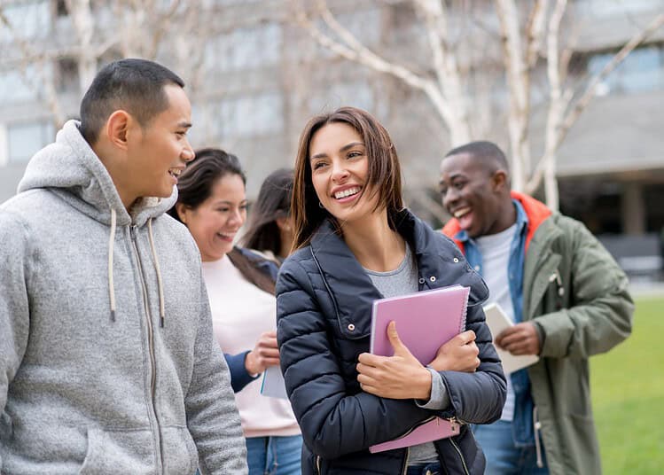 Études en France : voici les 10 villes préférées des étudiants Groupe d'étudiants étrangers souriants en extérieur en France.