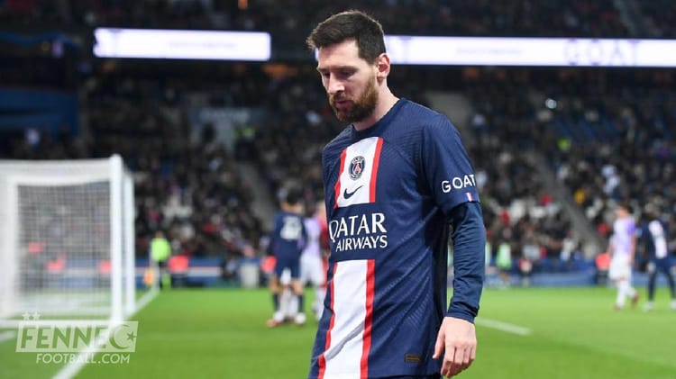 Joueur algérien en tenue du PSG sur le terrain de football.