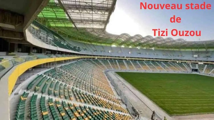 Nouveau Stade de Tizi Ouzou : une inauguration historique pour le football algérien Stade moderne de Tizi Ouzou avec sièges colorés et terrain vert.