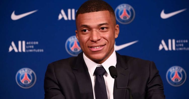 Kylian Mbappé souriant lors d'une conférence de presse au PSG.