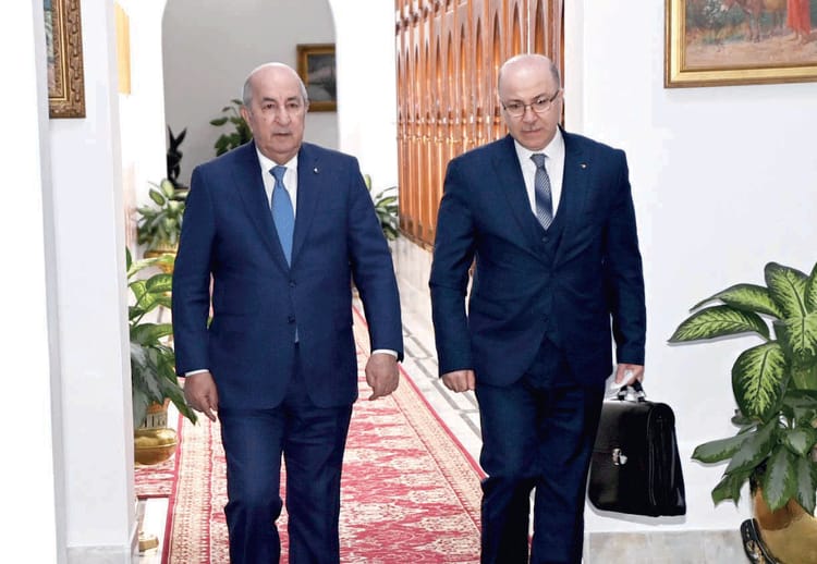 Sommet arabe de Djeddah : Tebboune absent, le 1er ministre le représente Deux hommes en costume dans un couloir du sommet arabe de Djeddah.