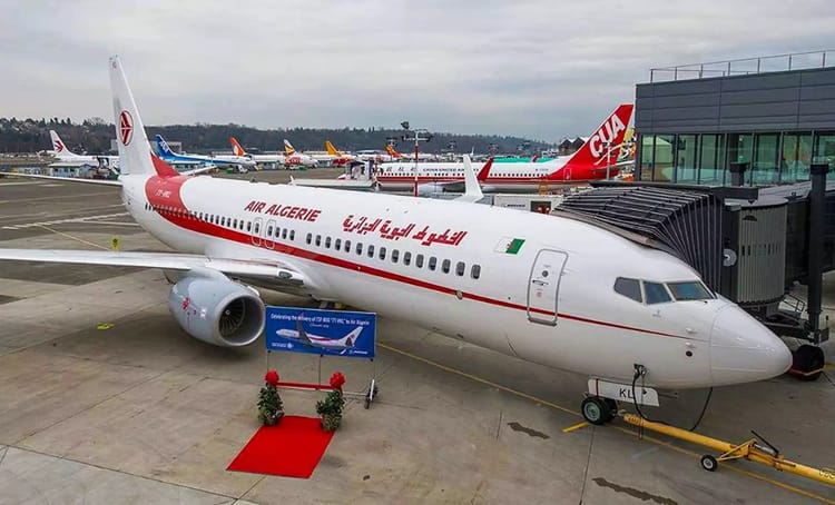 Avion Air Algérie stationné à l'aéroport avec d'autres avions en arrière-plan.