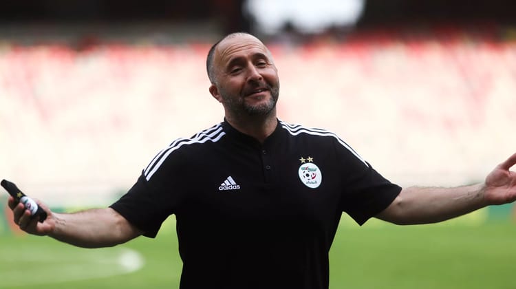 Équipe d'Algérie : Découvrez le nouvel attaquant qui captive Djamel Belmadi Entraîneur d'Algérie souriant sur le terrain de football.