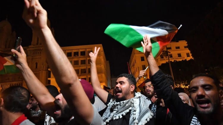 Manifestants pro-Gaza avec drapeaux en Tunisie lors d'une manifestation nocturne.